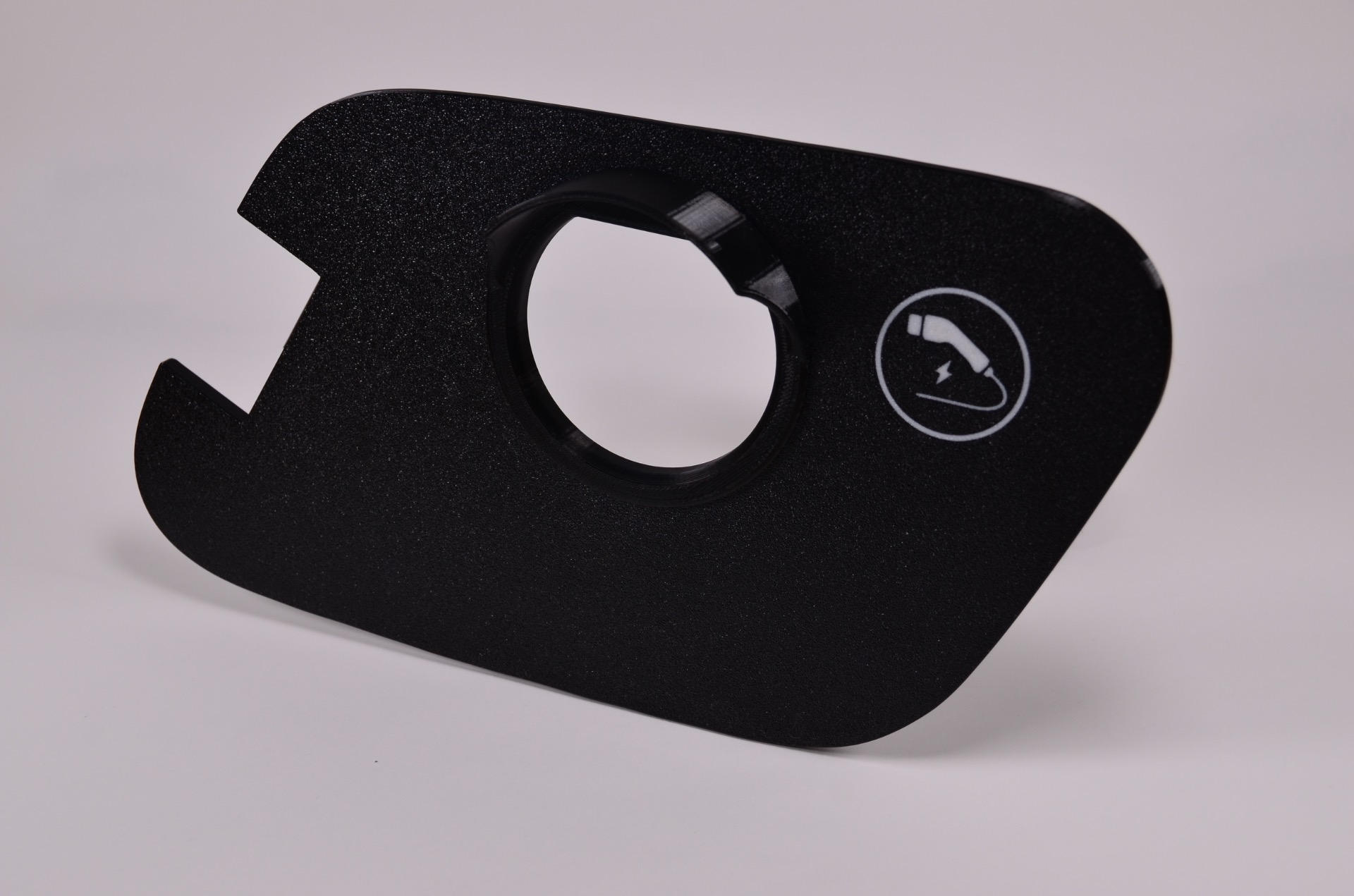 Ladedeksel med piktogram for frigjøring av ladekabel